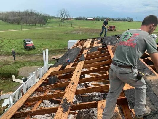 The family of Mitch Boggs helps to patch the damage left by wind and hail at the Langston home May 3, 2020. (Submitted photo)