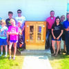 Left of the box are 4-H members Mitchell Gall, Delaney Gall, Brayden Schultz, Emma Sutton, Eli Sutton, and Mason Hayes. To the right of the box, Dadeville First Baptist Church members Brock Toler, Leah Toler, Kerri Toler, and Michael Toler.  (Submitted Photo)