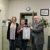 State Sen. Bill White presents a Missouri Senate resolution to Russell Abstract staffers Beth Killingsworth and Natalya Cornelius in recognition of the title company's over 150 years in business on March 8, 2019. (Photo by James McNary)