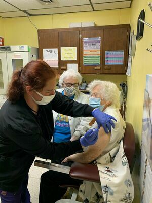 Leila Spicer, 100, receives her second dose of the COVID-19 vaccine from Christine Schultz, RN, while Ardella Lack, RN, observes on Monday, April 12 at the Dade County Health Department. Spicer is the oldest COVID-19 vaccine recipient yet seen by the DCHD. (Photo courtesy Pam Cramer, DCHD)
