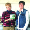 Connie Roseman, left, presents a plaque to Janice Theurer.