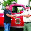 MDC Forestry Assistant Ben Buckner, right, presents the check to Dadeville Fire Chief Brian Sneed.